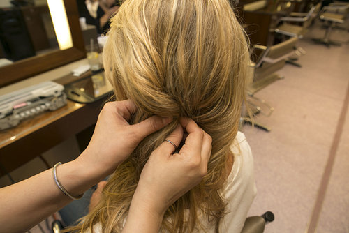 Pull your hair over to the side you want your braid to rest. Then, loosely twist a side section of hair behind your ear and pin in place. Later you'll join this twist with the braid you're about to create.
Pull your hair over to the side you want your braid to rest. Then, loosely twist a side section of hair behind your ear and pin in place. Later you'll join this twist with the braid you're about to create.