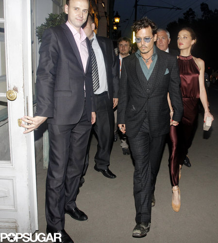 Johnny Depp held hands with Amber Heard in Moscow. Amber is carrying a Nancy Gonzalez clutch.
Johnny Depp held hands with Amber Heard in Moscow. Amber is carrying a Nancy Gonzalez clutch.