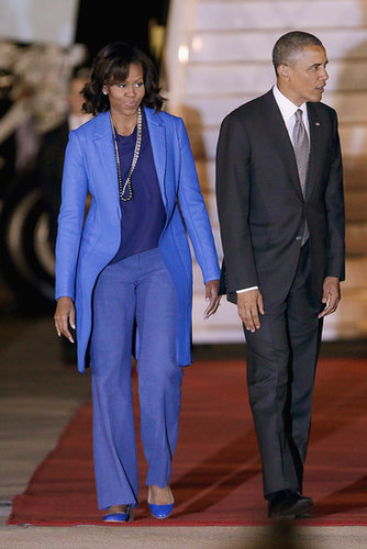Michelle Obama stuck to various shades of blue in Pretoria, South Africa. To break up the monochrome look, she wore two Pearl Paradise necklaces.
Michelle Obama stuck to various shades of blue in Pretoria, South Africa. To break up the monochrome look, she wore two Pearl Paradise necklaces.