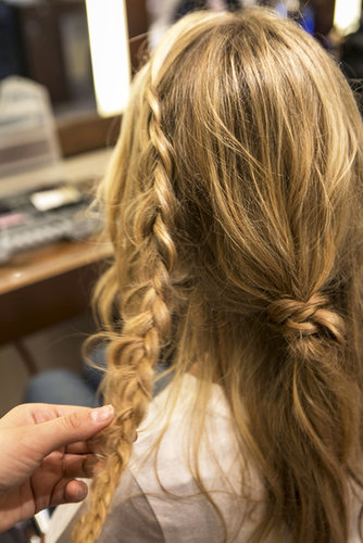 Continue to braid all the way down, and pull at the braid to give it extra texture and width before securing with an elastic.
Continue to braid all the way down, and pull at the braid to give it extra texture and width before securing with an elastic.