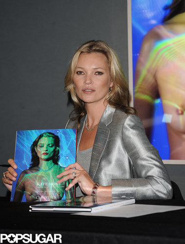 Only Kate Moss Can Rock a Silver Suit in Front of Her Own Topless Photo Only Kate Moss Can Rock a Silver Suit in Front of Her Own Topless Photo