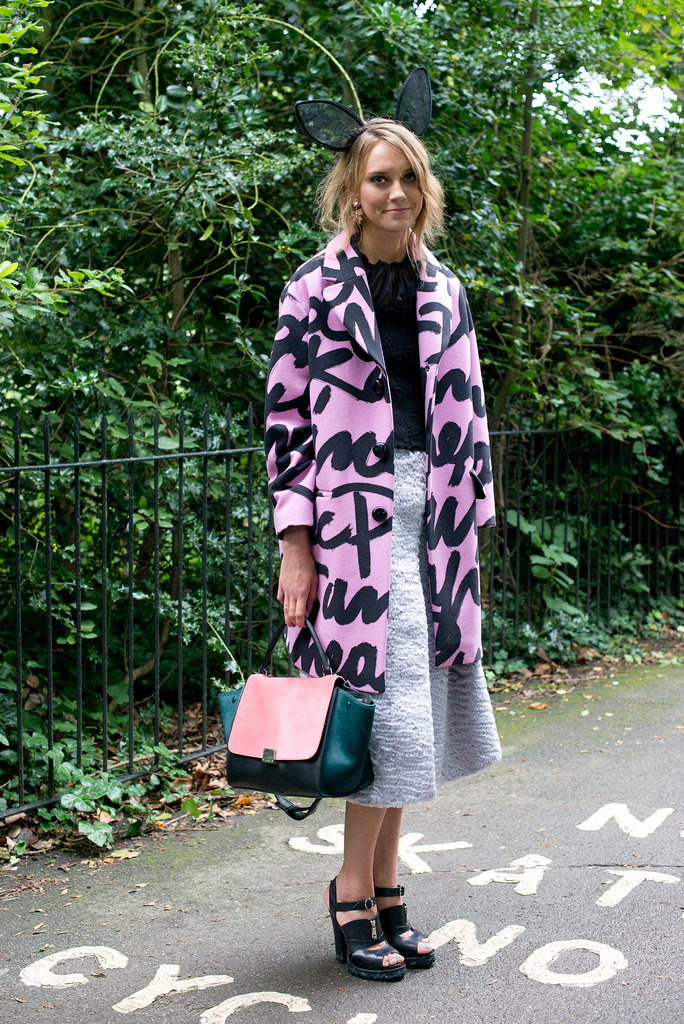 This showgoer didn't shy away from statement-making pieces, opting for bunny ears, a graffiti-printed coat, and a bright, colorblock Céline bag.
This showgoer didn't shy away from statement-making pieces, opting for bunny ears, a graffiti-printed coat, and a bright, colorblock Céline bag.