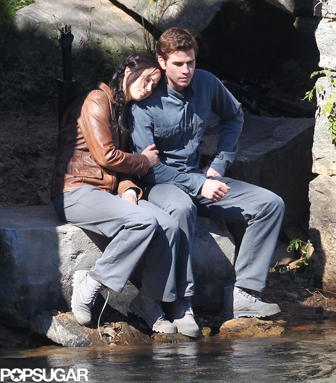 Jennifer Lawrence and Liam Hemsworth cuddled up while filming a scene together. Jennifer Lawrence and Liam Hemsworth cuddled up while filming a scene together.