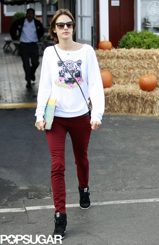 Alessandra Ambrosio ran errands in a white sweater with a tiger and flowers emblazoned on it, deep red skinny jeans, and high-top Ash sneakers.
Alessandra Ambrosio ran errands in a white sweater with a tiger and flowers emblazoned on it, deep red skinny jeans, and high-top Ash sneakers.