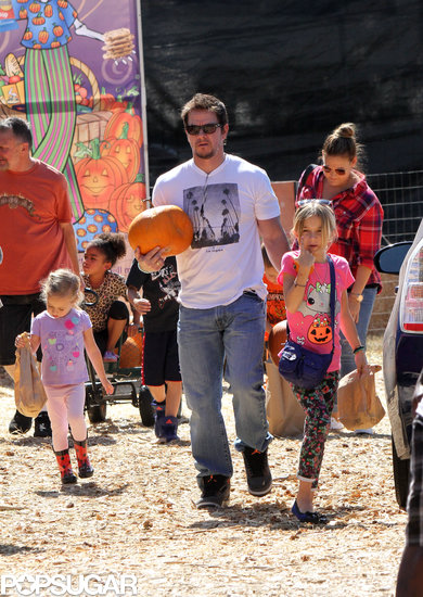 Mark Wahlberg walked through a pumpkin patch with his kids. Mark Wahlberg walked through a pumpkin patch with his kids.