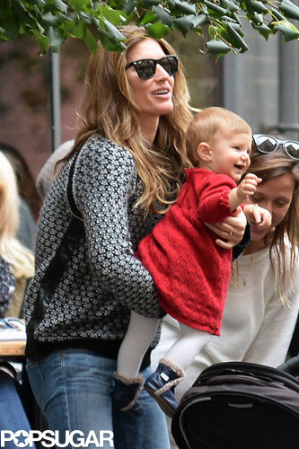 Gisele Bündchen held on to her smiling baby.
Gisele Bündchen held on to her smiling baby.