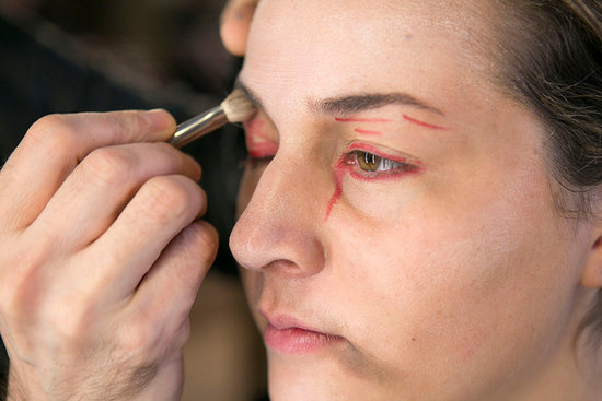 After you've gone pale, hollow out your eyes with a taupe shadow all around your eye sockets. Don't forget to go around your nose, along your cheekbones, and around the contours of your mouth. Bouchard used the brown shades from the Monster's Bride Pro Palette x6 ($44).
Next, he created the beginnings of a bloody stare by lining the eyes with a red Lip Pencil ($20). He also drew on bloody cuts, and went back and blended everything with a brush.
After you've gone pale, hollow out your eyes with a taupe shadow all around your eye sockets. Don't forget to go around your nose, along your cheekbones, and around the contours of your mouth. Bouchard used the brown shades from the Monster's Bride Pro Palette x6 ($44).
Next, he created the beginnings of a bloody stare by lining the eyes with a red Lip Pencil ($20). He also drew on bloody cuts, and went back and blended everything with a brush.