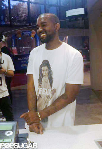 Forget about wearing your heart on your sleeve, Kanye West wears Kim Kardashian on his shirt. Before kicking off his Yeezus tour in Seattle on Oct. 19, the rapper mingled with fans while wearing a t-shirt that featured a photo of Kim from her 2007 nude photo shoot for Playboy with the words "Yeezus" written over the NSFW parts.
Forget about wearing your heart on your sleeve, Kanye West wears Kim Kardashian on his shirt. Before kicking off his Yeezus tour in Seattle on Oct. 19, the rapper mingled with fans while wearing a t-shirt that featured a photo of Kim from her 2007 nude photo shoot for Playboy with the words "Yeezus" written over the NSFW parts.