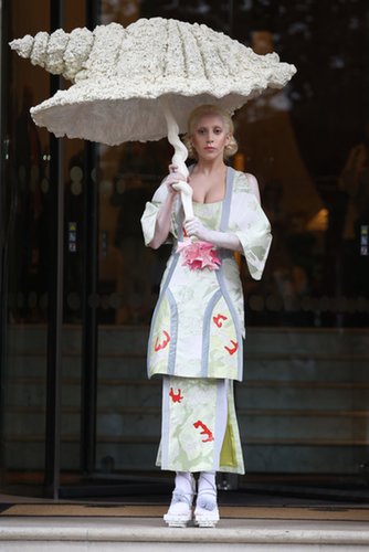 On Halloween, Lady Gaga was seen in a floral kimono-inspired dress, which she accessorized with an umbrella in the shape of a seashell.
On Halloween, Lady Gaga was seen in a floral kimono-inspired dress, which she accessorized with an umbrella in the shape of a seashell.