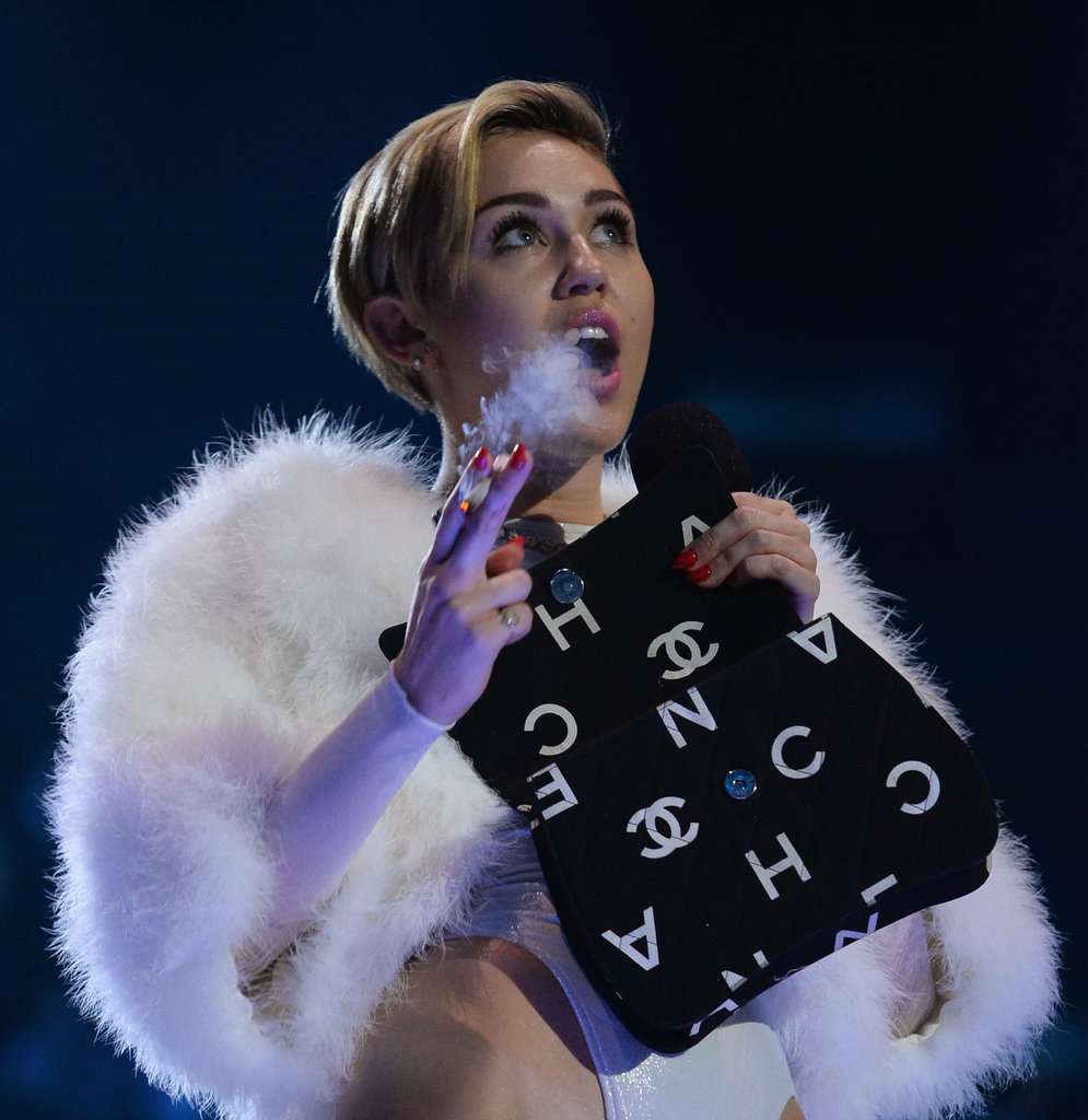 Miley Cyrus isn't shy about lighting up wherever she wants. After all, the singer famously smoked a joint on stage at the 2013 MTV European Music Awards in Amsterdam, the Netherlands. Miley opened up about her views on drugs during an interview with Rolling Stone. "Hollywood is a coke town, but weed is so much better. And Molly, too," she said. "Those are happy drugs — social drugs. They make you want to be with friends. You're out in the open. You're not in a bathroom."
Miley Cyrus isn't shy about lighting up wherever she wants. After all, the singer famously smoked a joint on stage at the 2013 MTV European Music Awards in Amsterdam, the Netherlands. Miley opened up about her views on drugs during an interview with Rolling Stone. "Hollywood is a coke town, but weed is so much better. And Molly, too," she said. "Those are happy drugs — social drugs. They make you want to be with friends. You're out in the open. You're not in a bathroom."