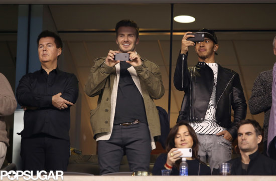 David Beckham and Lewis Hamilton captured the game on their phones. David Beckham and Lewis Hamilton captured the game on their phones.