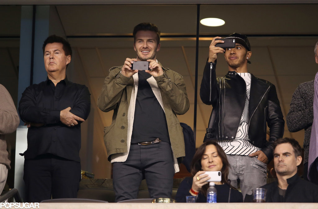 David Beckham and Lewis Hamilton captured the game on their phones. David Beckham and Lewis Hamilton captured the game on their phones.