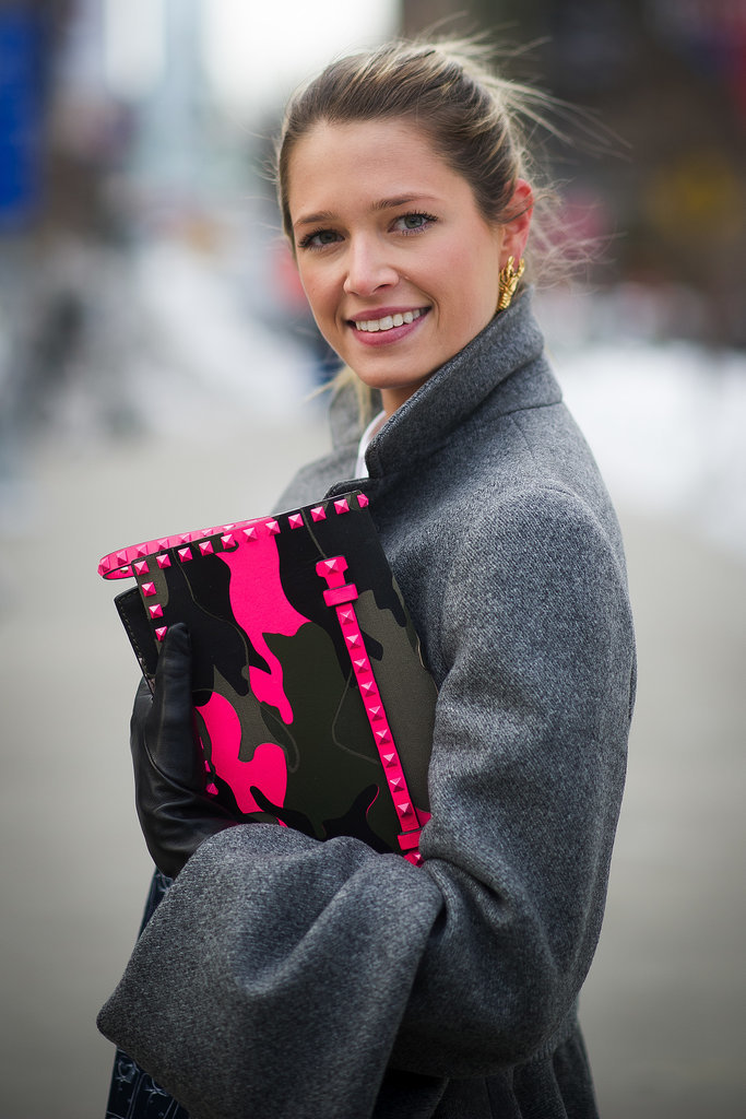 Helena Bordon lit up a gray coat with a neon and camo-printed Valentino clutch.
Helena Bordon lit up a gray coat with a neon and camo-printed Valentino clutch.