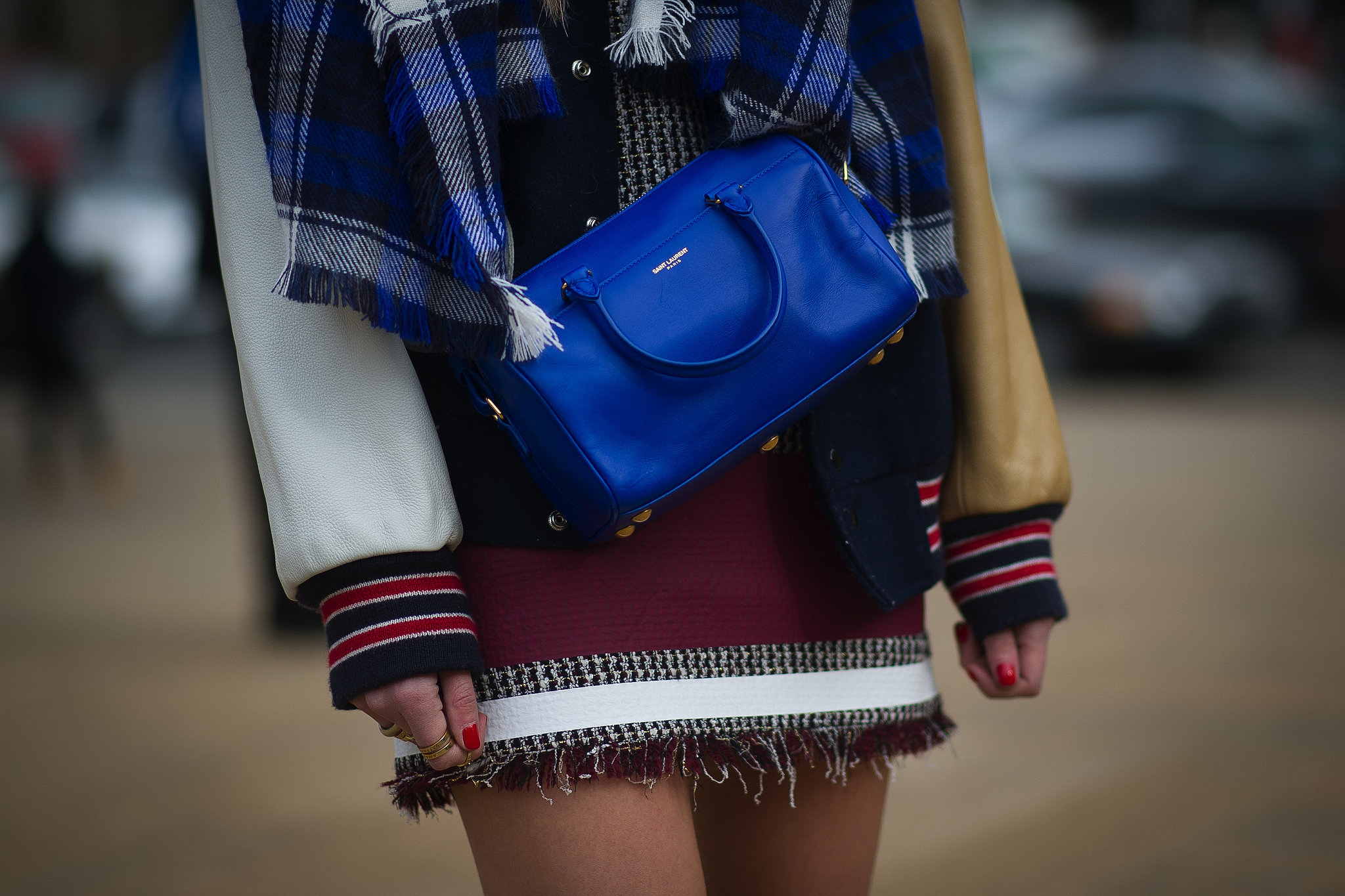 Chiara Ferragni dressed up a varsity jacket with a bright blue Saint Laurent bag. 
