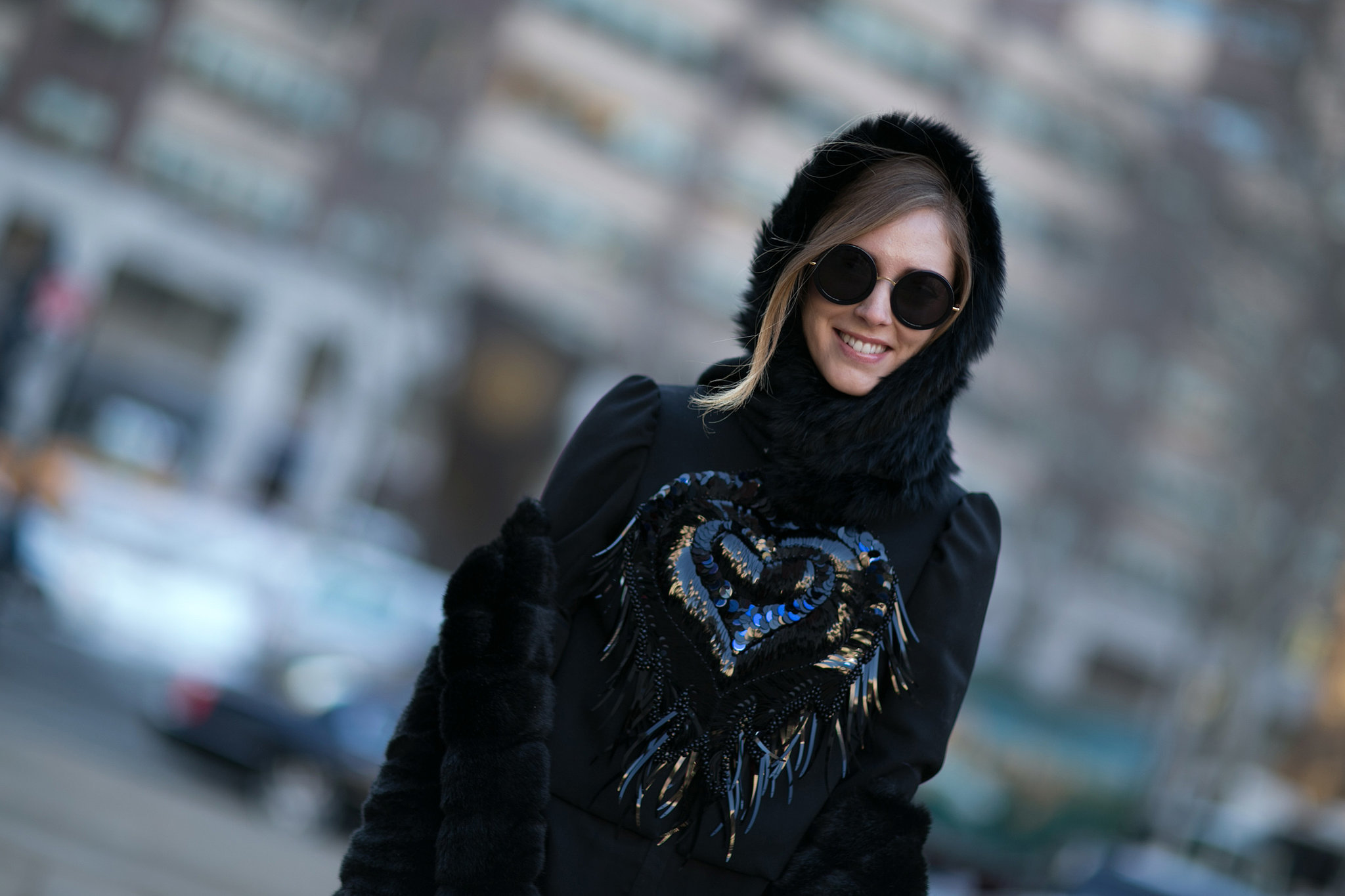 Chiara Ferragni accessorized with black shades and a cozy hood. 
