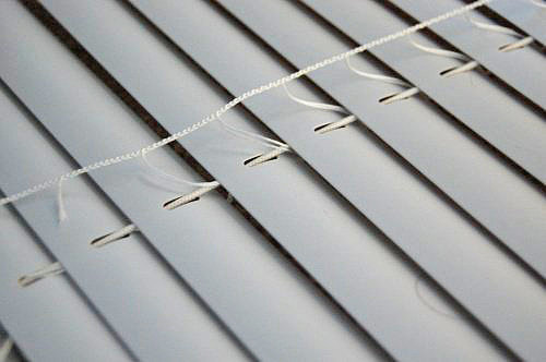 Open your blinds fully, and cut the ladder part that holds all the blind slats in place. Do not cut the cord that runs straight through each slat.
Source: Made2Style
Open your blinds fully, and cut the ladder part that holds all the blind slats in place. Do not cut the cord that runs straight through each slat.
Source: Made2Style