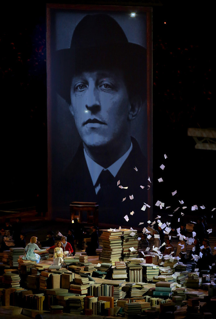 Stacks of books sat beneath each portrait, with book pages fluttering in the air like confetti.
