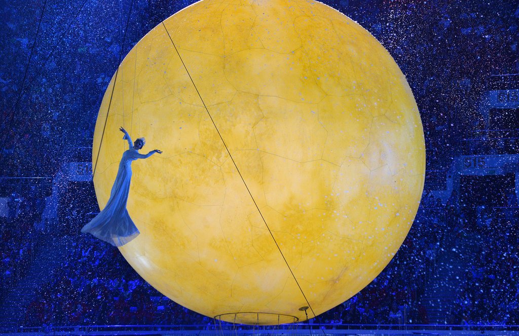 A performer could be seen dancing in midair beside the glowing sun.
