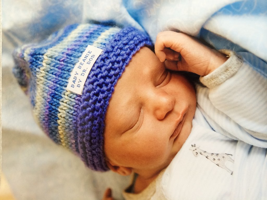 Since starting his knitting adventure, Sansonetti has made more than 200 hats, each one taking about four hours to create. Though his job keeps him busy, Sansonetti finds time to knit while waiting for his patients to go into labor. But the gift is more than an act of kindness. It is also a medical necessity, as newborns can lose a lot of heat from their head and need to stay warm. While most hospitals provide hats for that purpose, Sansonetti says his "give the baby a special, unique personality that doesn't seem to shine through with the standard hat." Not to mention, it makes the mothers very happy. 
Source: Dr. Robert Sansonetti
