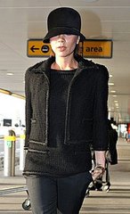 Victoria Beckham in Black Tweed Jacket and Hat at Heathrow Airport in London