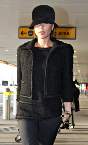 Victoria Beckham in Black Tweed Jacket and Hat at Heathrow Airport in London