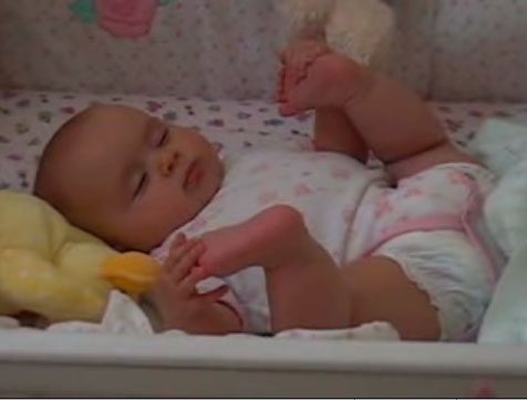 Baby Sleeps Holding Feet