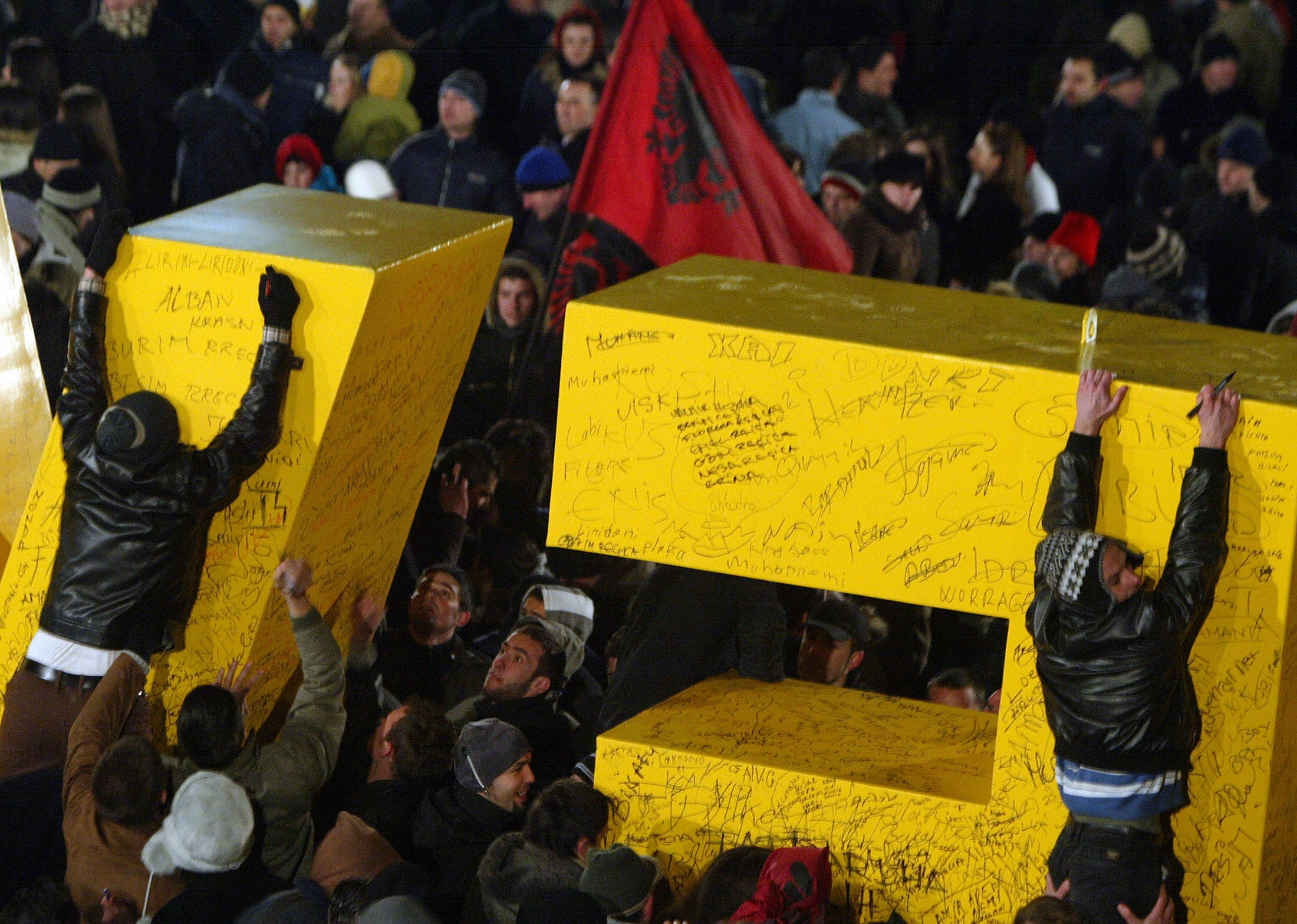 Kosovars climb letters reading "New Born" in Pristina on February 17, 2008. Kosovars climb letters reading "New Born" in Pristina on February 17, 2008.