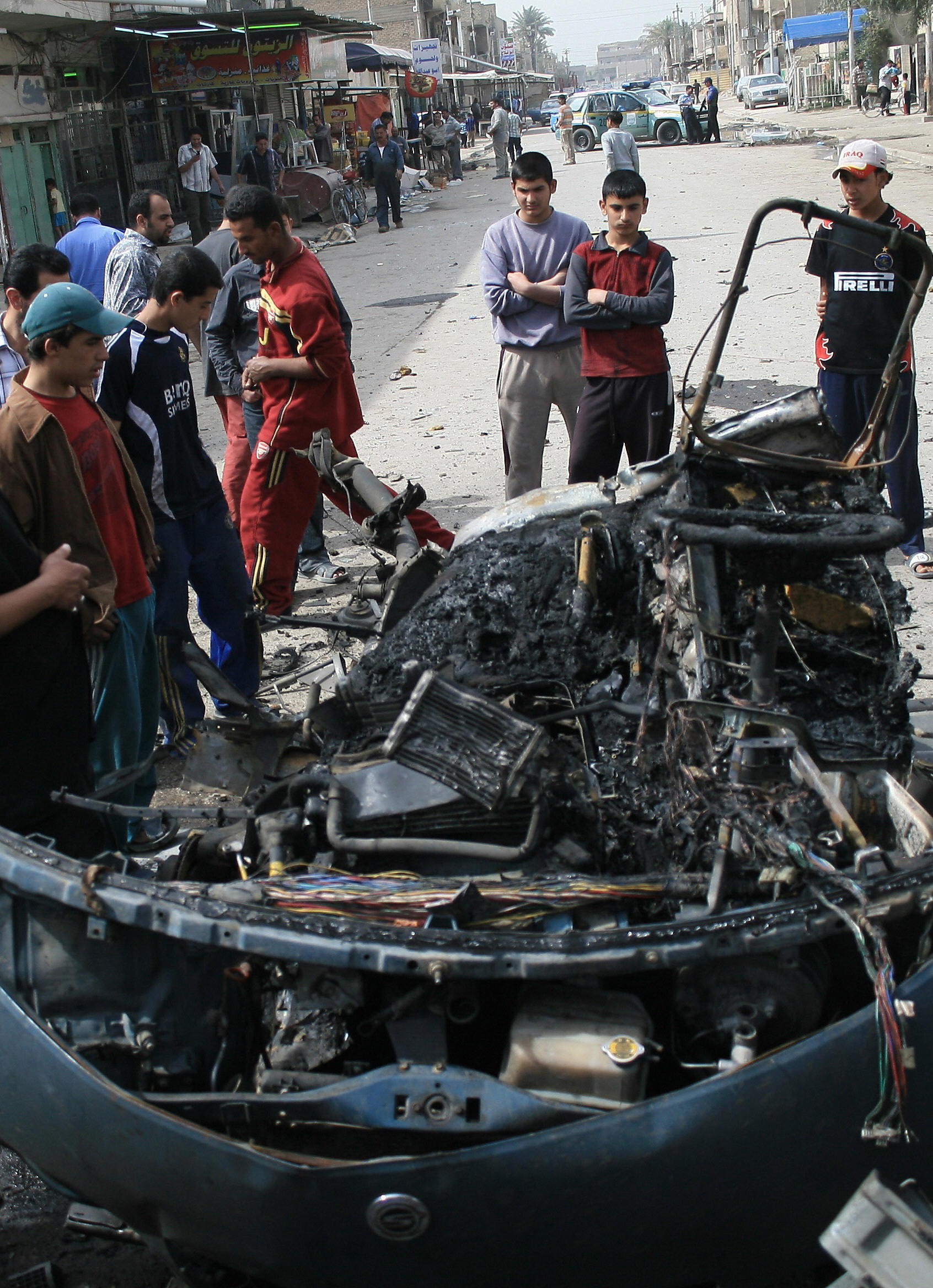 Iraqi youths gather around the wreckage of a car at the scene of an explosion in Baghdad's Al-Shaab neighborhood on Mar 10, 2007 Iraqi youths gather around the wreckage of a car at the scene of an explosion in Baghdad's Al-Shaab neighborhood on Mar 10, 2007