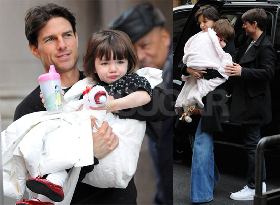 Tom and Katie Carry a Bundled up Suri