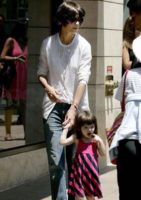 Katie and Suri Stride Down the Sidewalk Katie and Suri Stride Down the Sidewalk