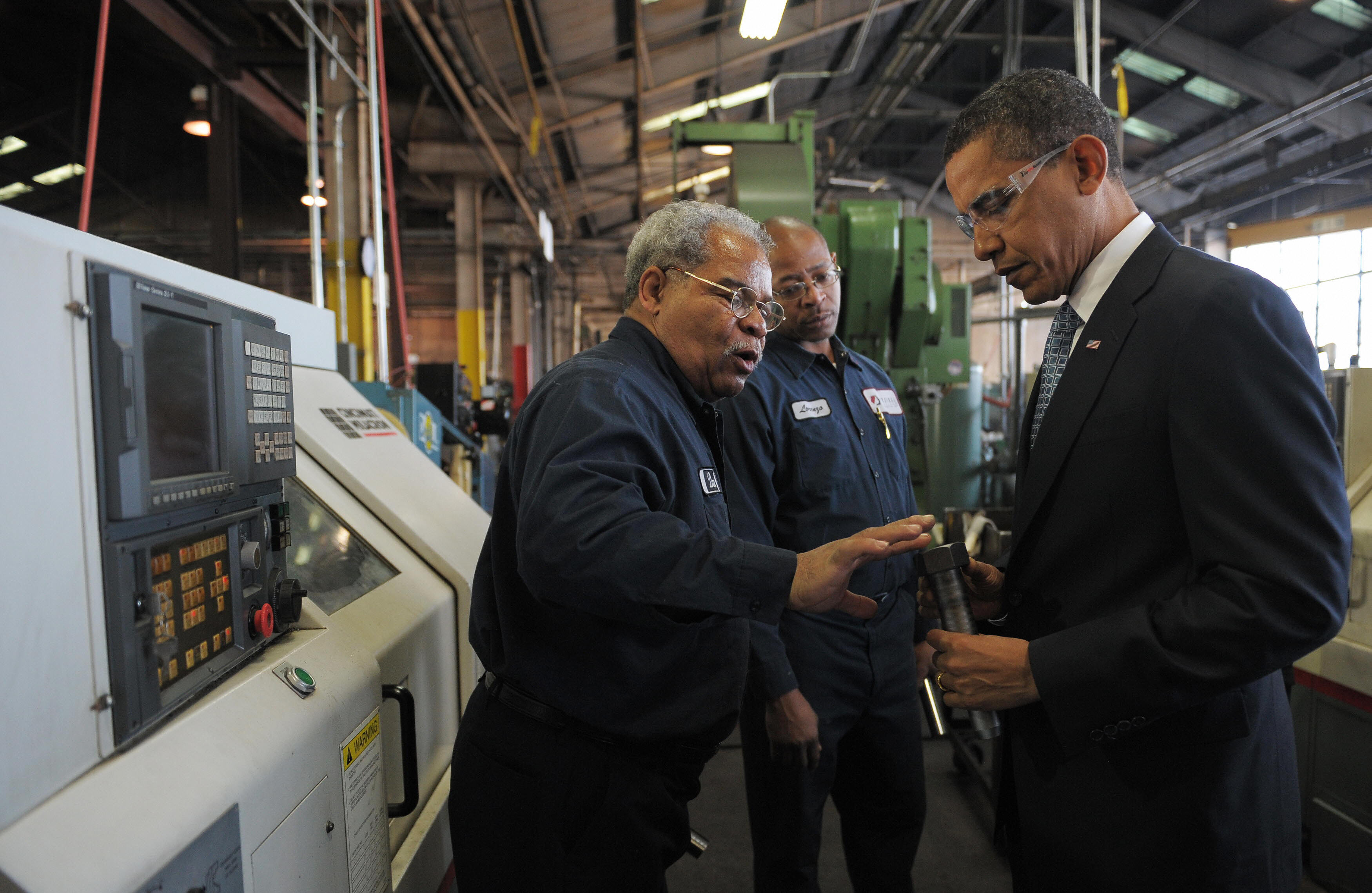 Barack Obama picks up a bolt during a tour of the Cardinal Fastener & Specialty Company factory. Barack Obama picks up a bolt during a tour of the Cardinal Fastener & Specialty Company factory.
