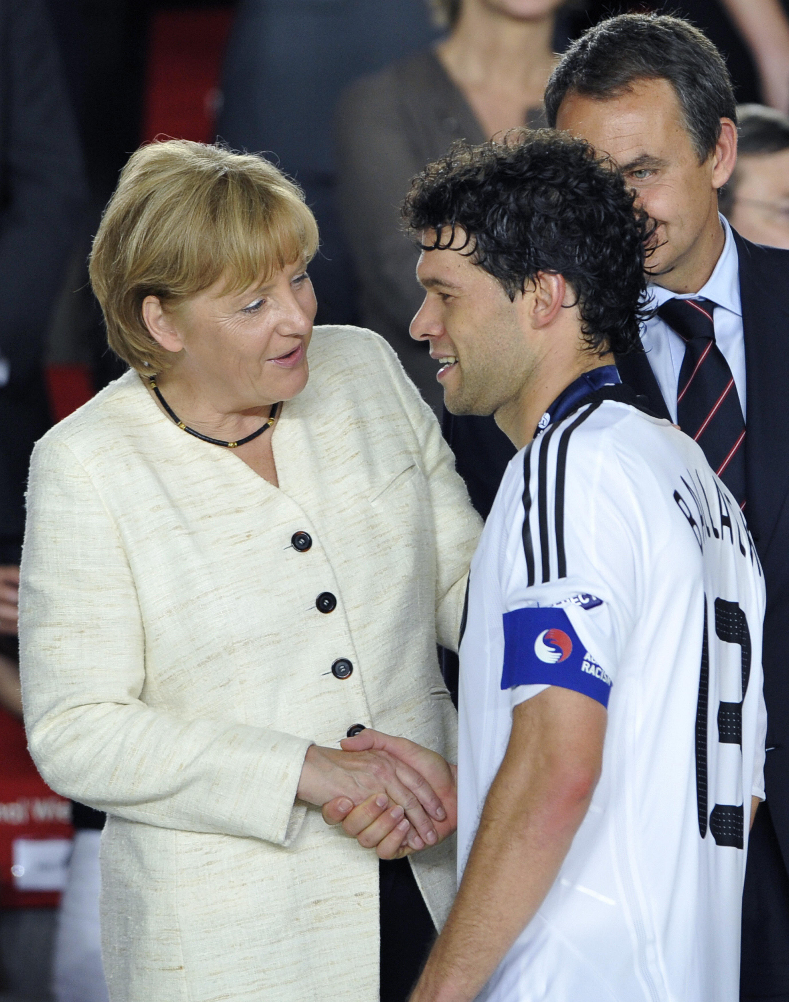 Better luck next time. German Chancellor Angela Merkel shakes hands with German midfielder and captain Michael Ballack. Better luck next time. German Chancellor Angela Merkel shakes hands with German midfielder and captain Michael Ballack.