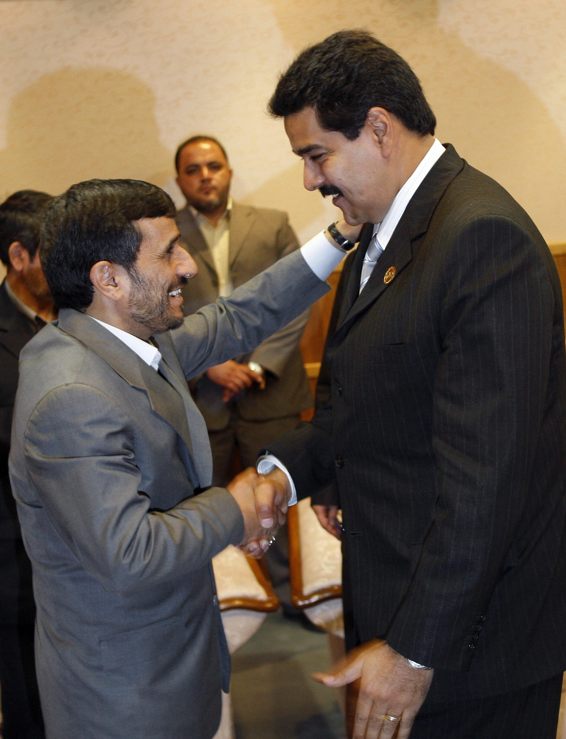 Iranian President Mahmoud Ahmadinejad shakes hands with Venezuela's Foreign Minister Nicolas Maduro. Iranian President Mahmoud Ahmadinejad shakes hands with Venezuela's Foreign Minister Nicolas Maduro.