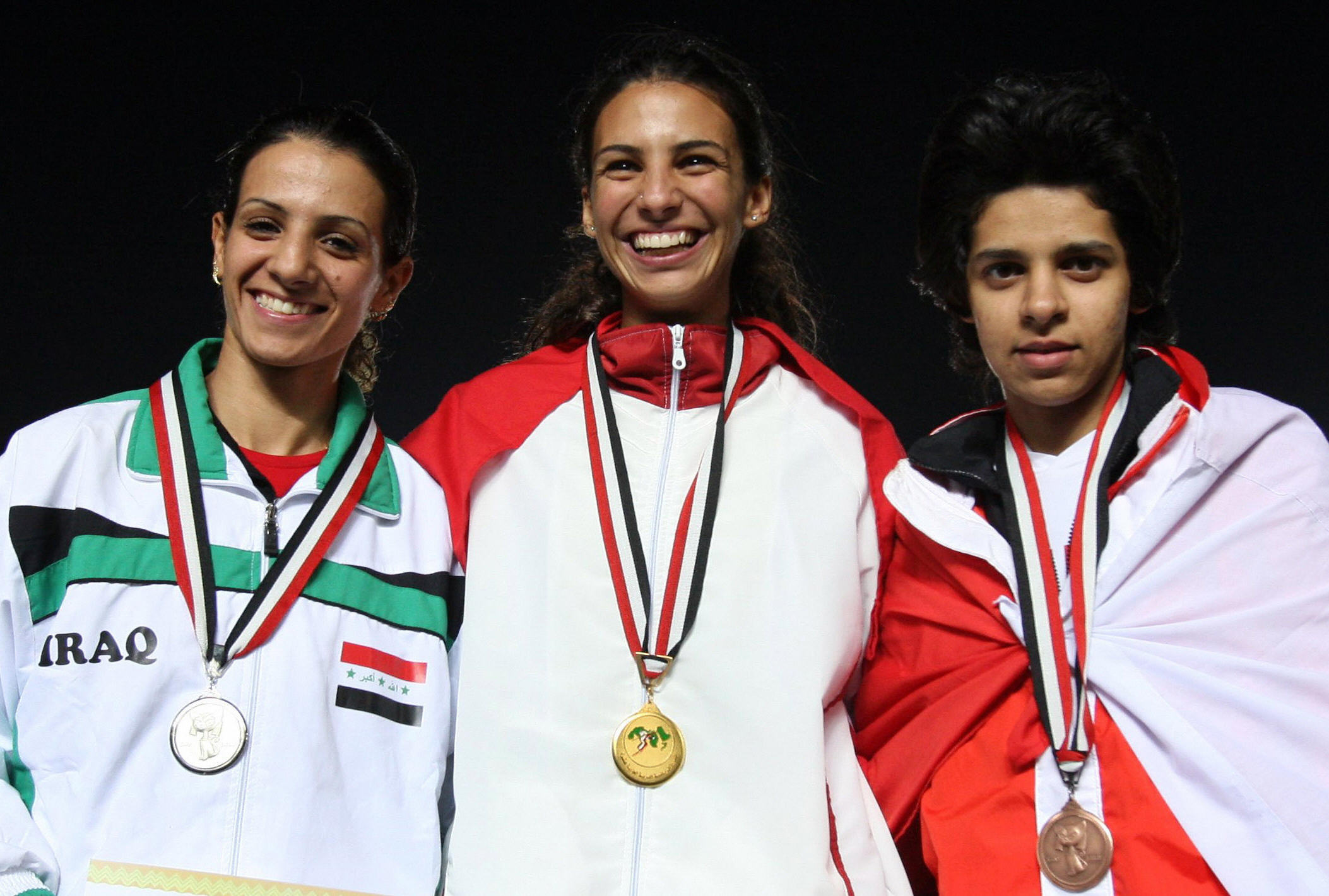 Dana Abdul Razzaq of Iraq (L) poses on the podium after winning the silver medal for the 100m race during the Pan Arab Games. Dana Abdul Razzaq of Iraq (L) poses on the podium after winning the silver medal for the 100m race during the Pan Arab Games.