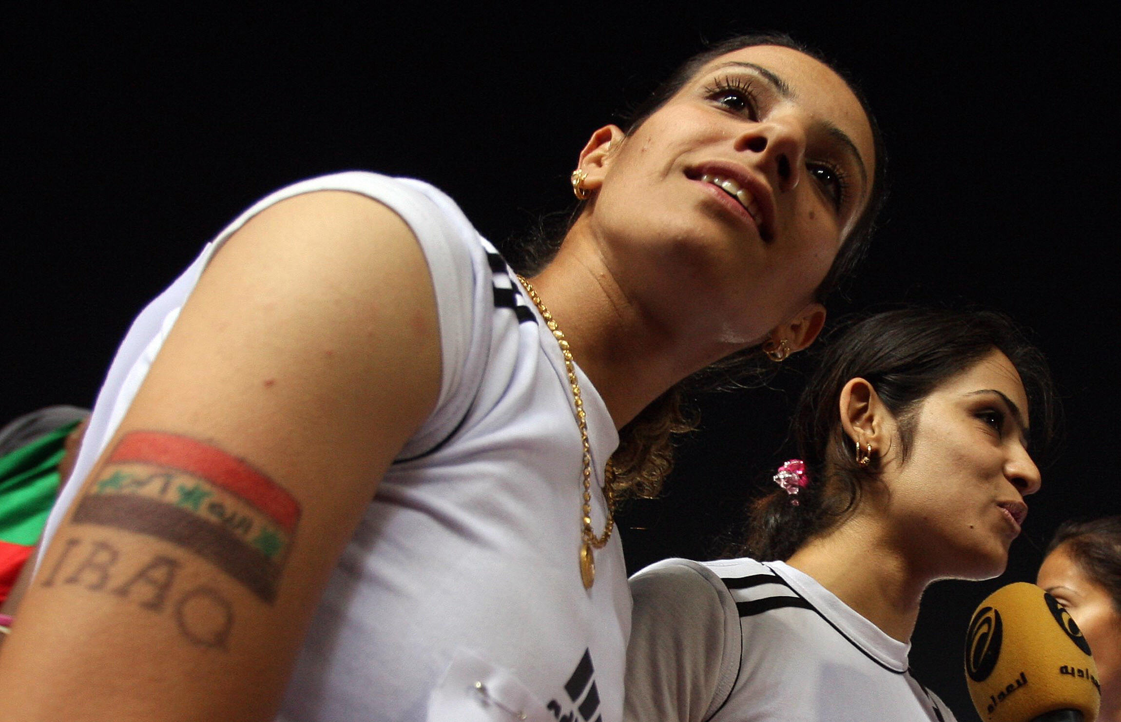 Iraqi sprinter Razzaq (L) stands with teammates as they speak to the press. Iraqi sprinter Razzaq (L) stands with teammates as they speak to the press.