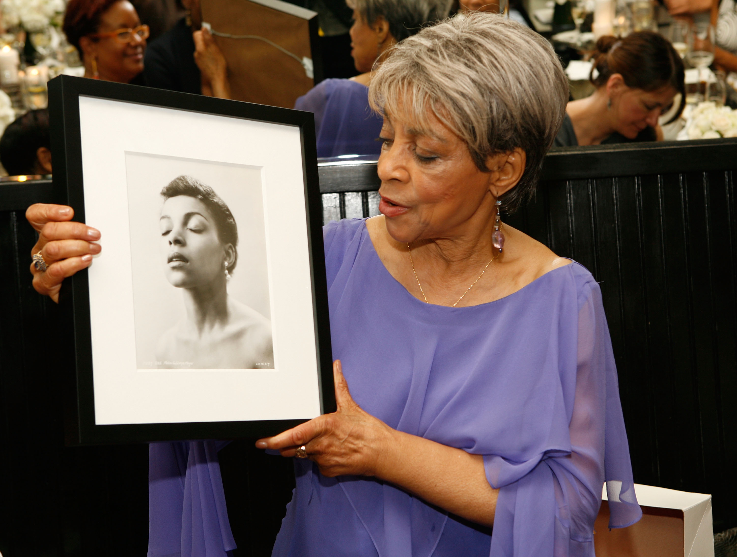 Checking a picture of her younger self out at the Ruby Dee Style Celebration in June, 2008. Checking a picture of her younger self out at the Ruby Dee Style Celebration in June, 2008.