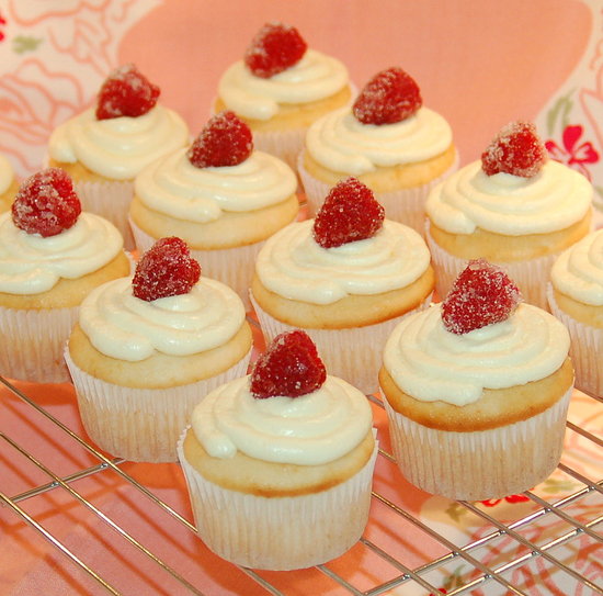 Lemon cupcakes with lemon buttercream and sugared raspberries.