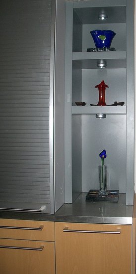 There is lighting in each of the Bulthaup shelving units for the displays of glass.