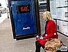 Fitness First Advertisement at Bus Stop Includes a Scale