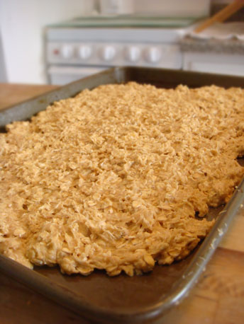 Spreading the dough on the cookie sheet Spreading the dough on the cookie sheet