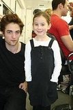 Robert Pattinson taking picture with a little girl ;)